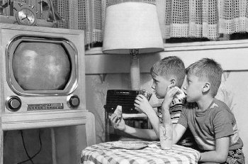 Boys watching old black and white TV 1960s